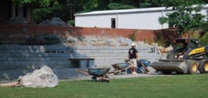 Workers and wheelbarrows during the 2011 reconstruction of the Lafayette-Pointer Park amphitheater retaining wall