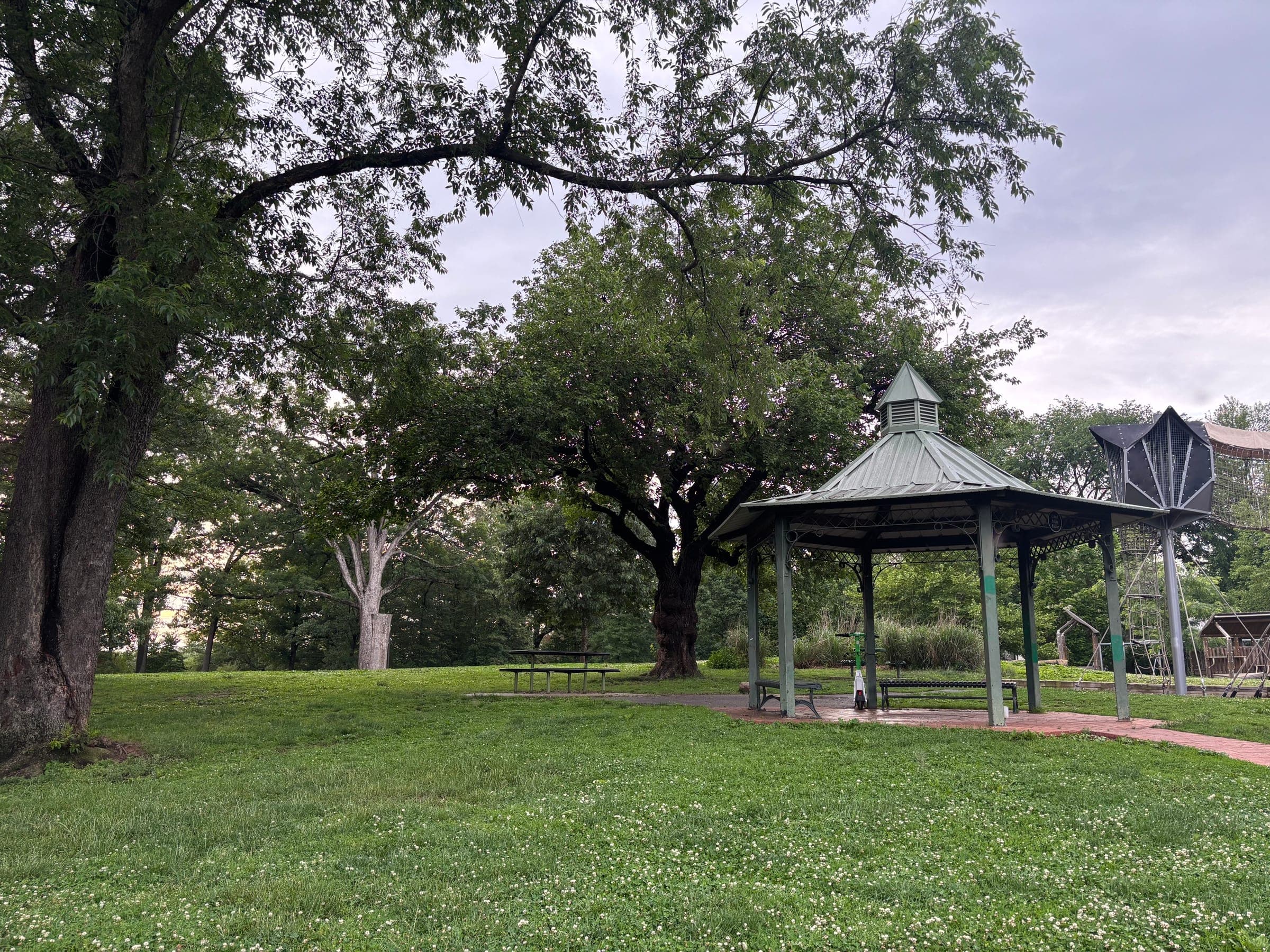 The green-roofed gazebo and picnic area beneath shade trees at Lafayette-Pointer Park